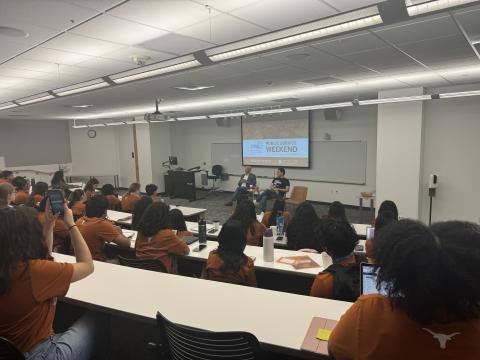 Students listen to remarks from the dean