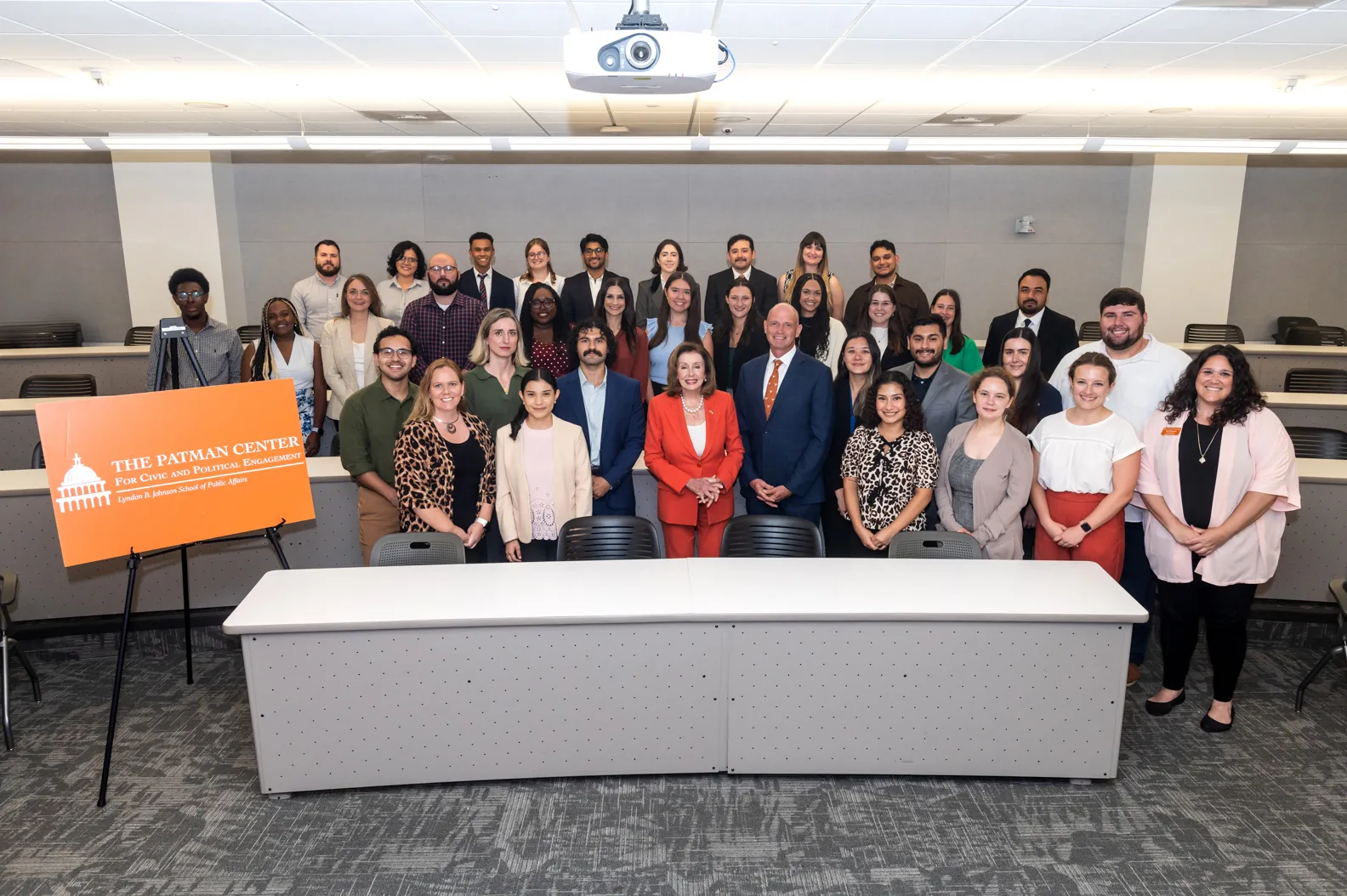 Nancy Pelosi standing with a group of students