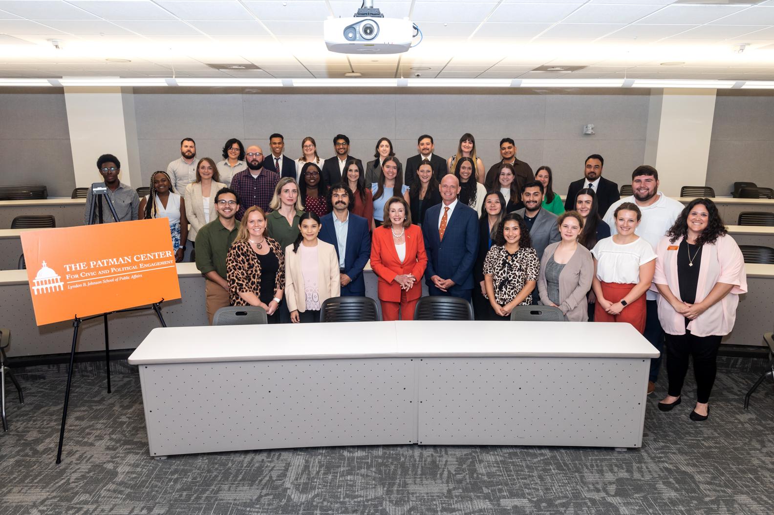 Nancy Pelosi standing with a group of students