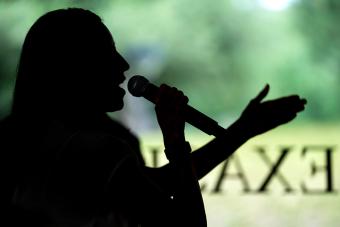 silhouette of person speaking into microphone